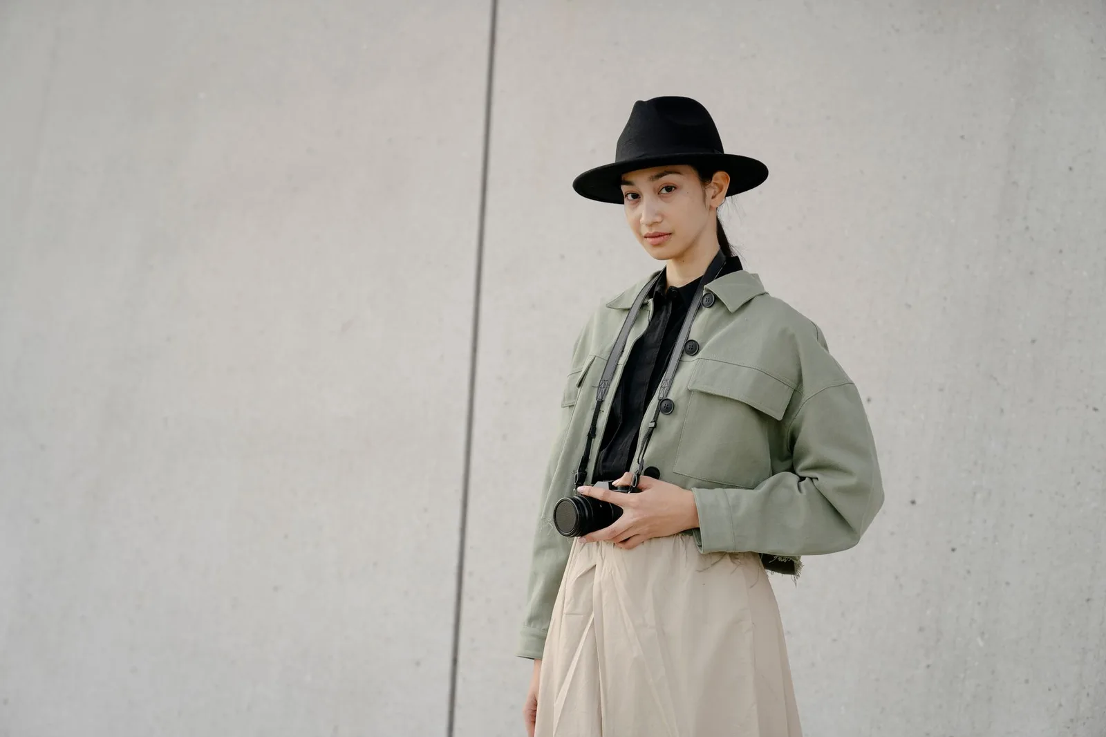 An outfit combining an olive jacket with neutral basics