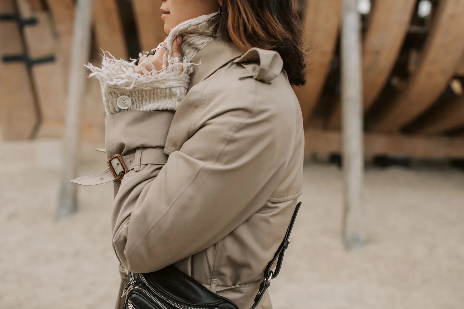 A person in a layered outfit with a jacket over a hooded sweatshirt