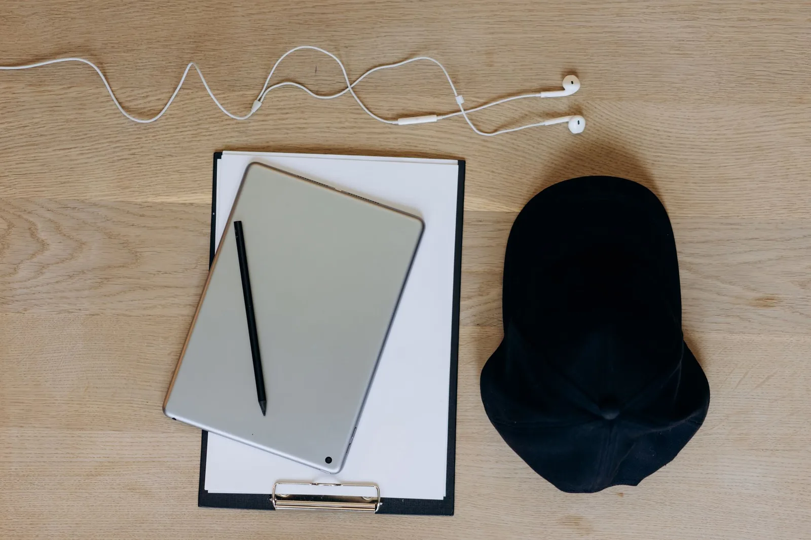A cap, a beanie, and a canvas bag arranged together