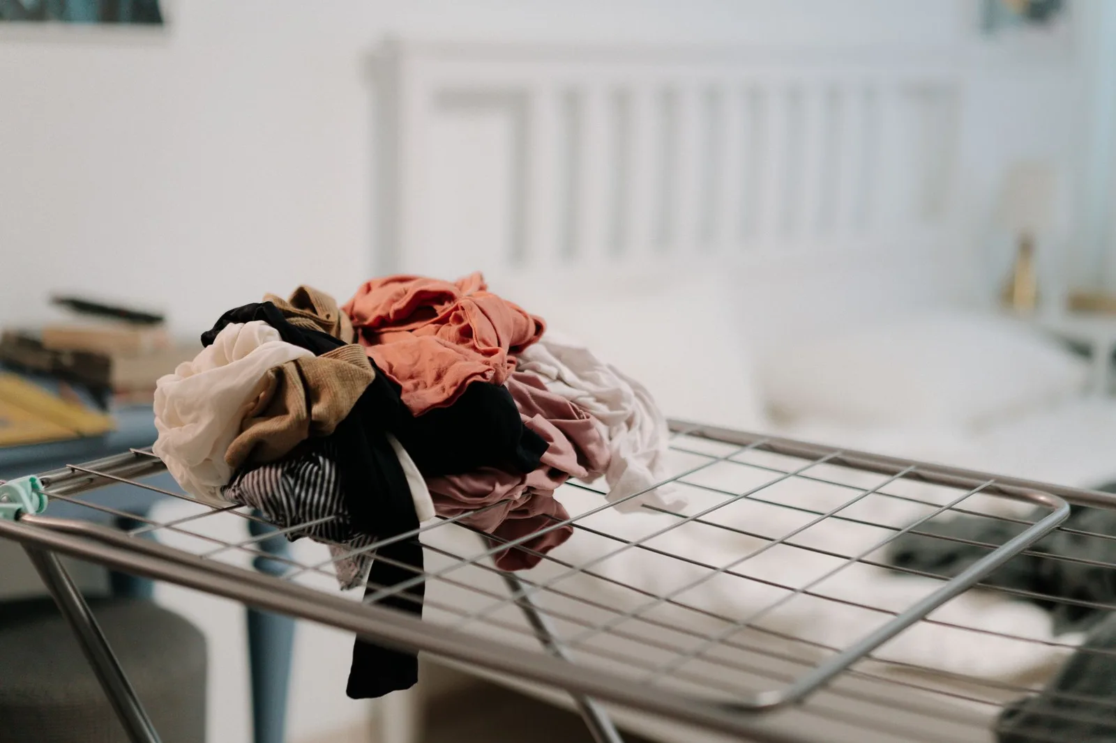 Shirts hanging to dry on an indoor drying rack