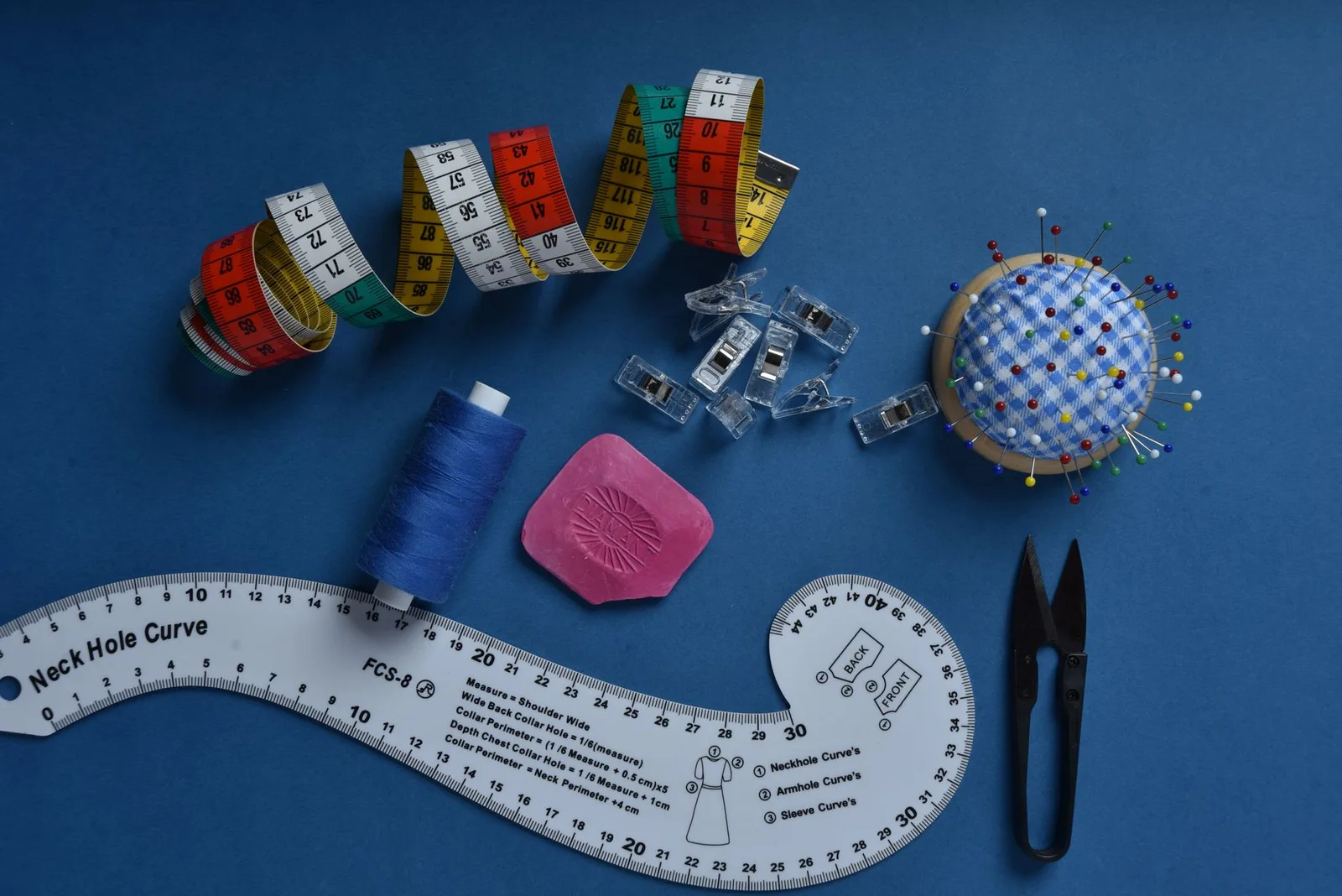 A tape measure resting on a folded garment