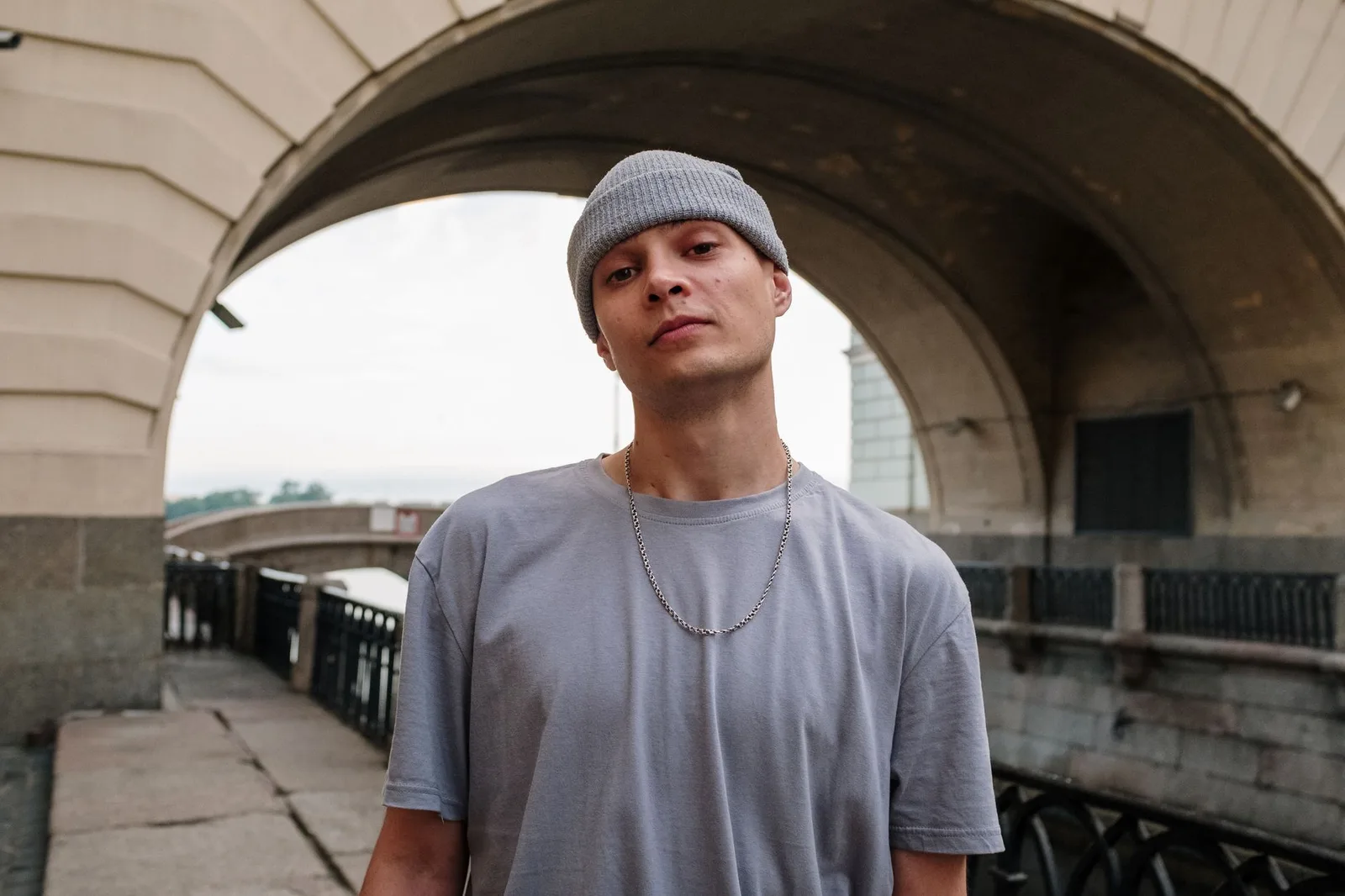 A person wearing a relaxed-fit T-shirt with the shoulder seam sitting below the shoulder