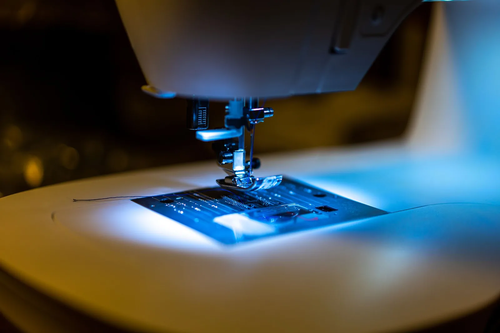 An embroidery machine stitching thread into fabric