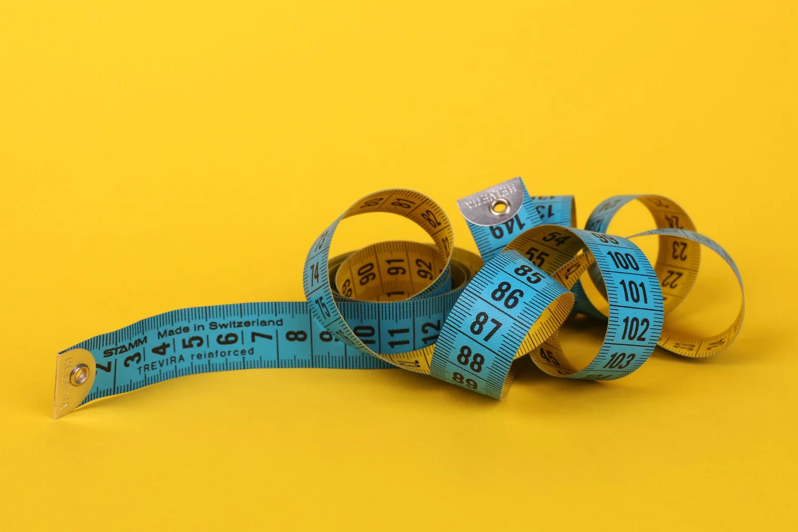 A tape measure and folded shirts used for checking measurements