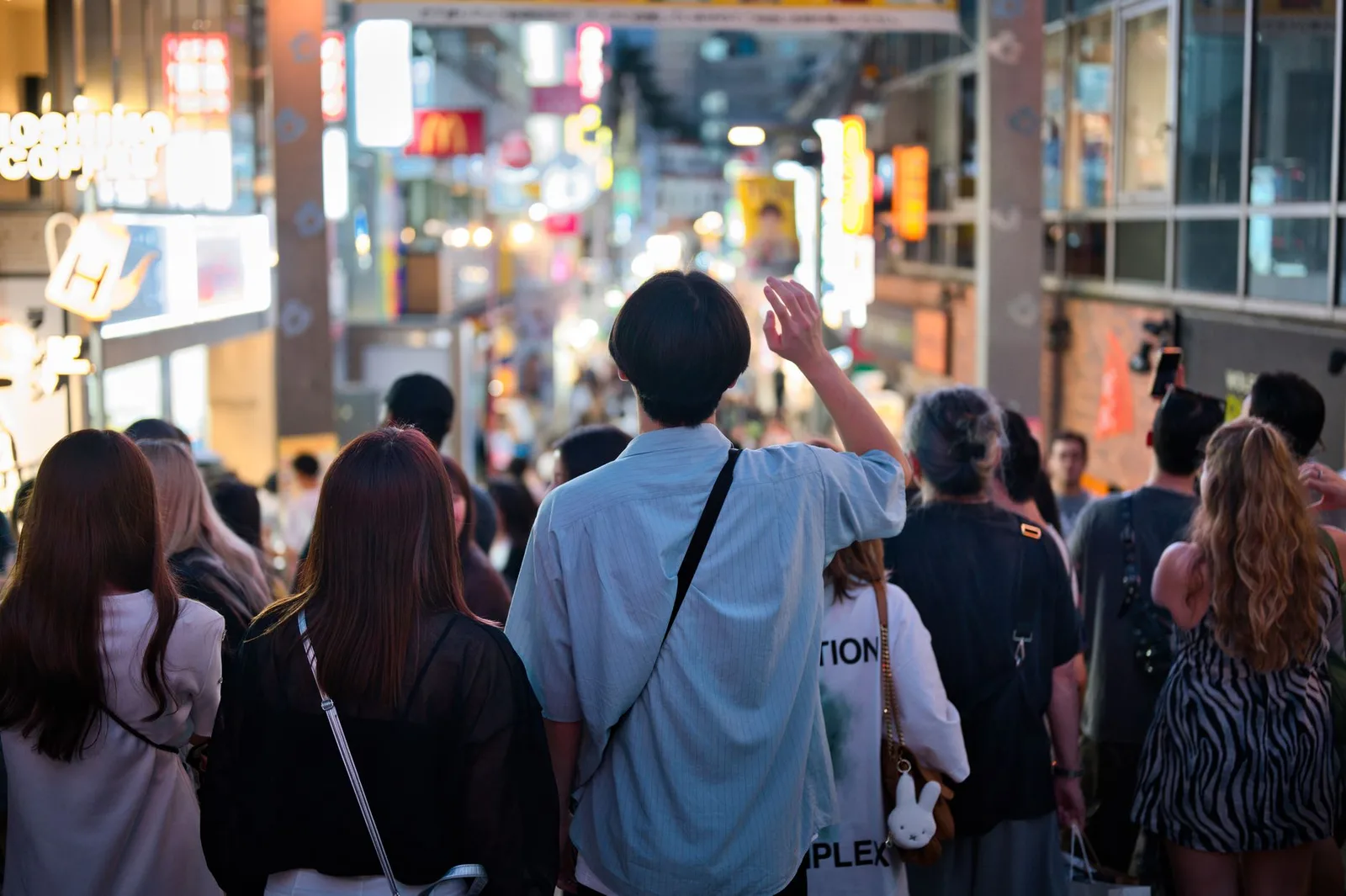 People in varied everyday clothing on a city street