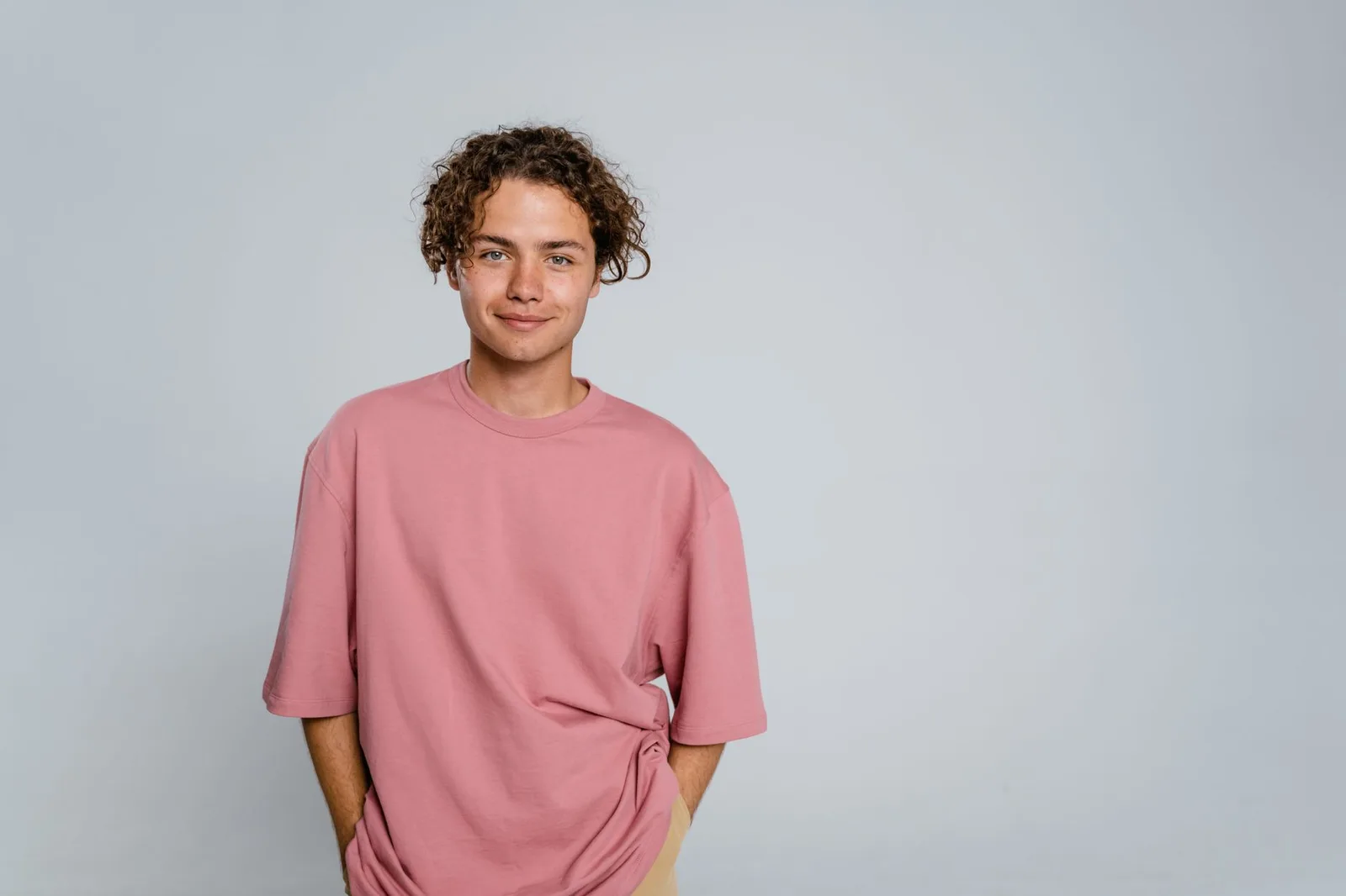 A person wearing a T-shirt whose shoulder seam sits at the edge of the shoulder